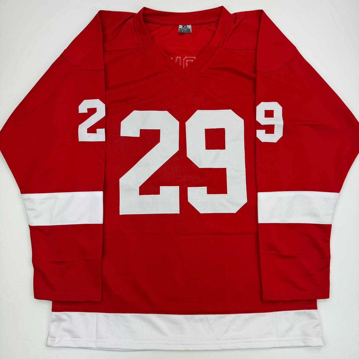 Red and white Detroit Red Wings hockey jersey with number 29 displayed on front, laid flat against white background.