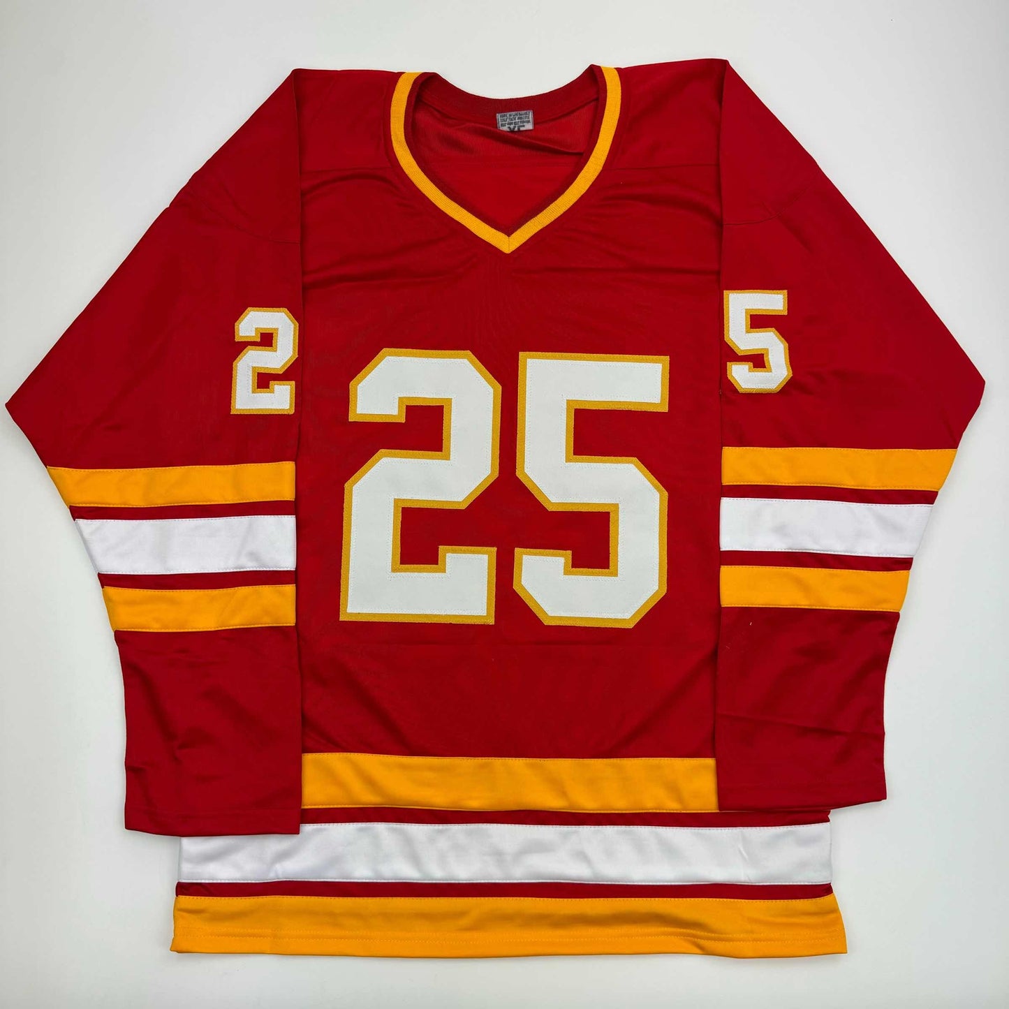 Red hockey jersey with white and gold number 25, gold and white striped sleeves, displayed flat against white background.