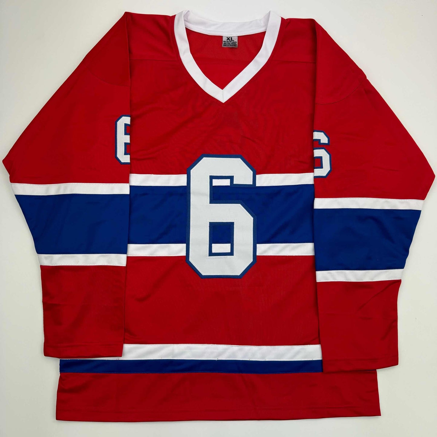 Red, white, and blue striped Montreal Canadiens hockey jersey with number 6 displayed flat against white background.