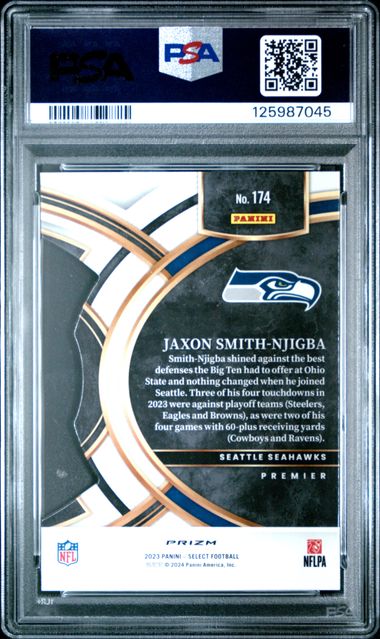 Back of graded 2023 Panini Select Jaxon Smith-Njigba rookie card in PSA holder, showing player bio text, Seattle Seahawks logo, and silver prizm die-cut design.