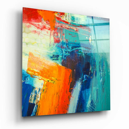 Angled view of a glass wall art panel displaying bold orange, teal, and blue abstract brushstrokes with layered translucent effects.