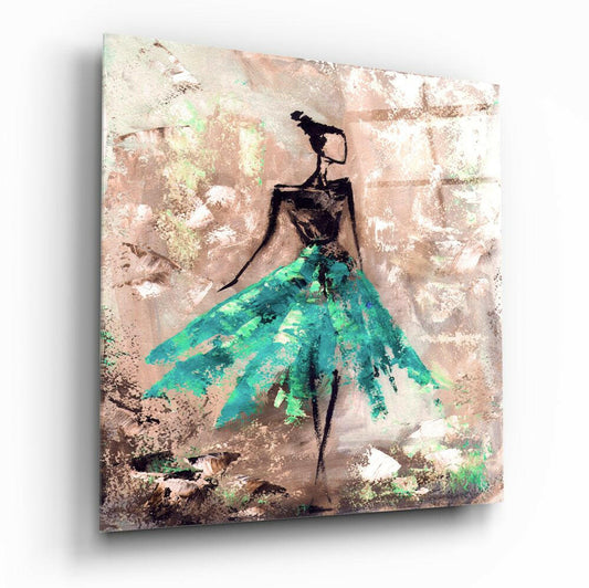 Angled view of glass wall art showing stylized figure in turquoise skirt against textured beige and cream background.