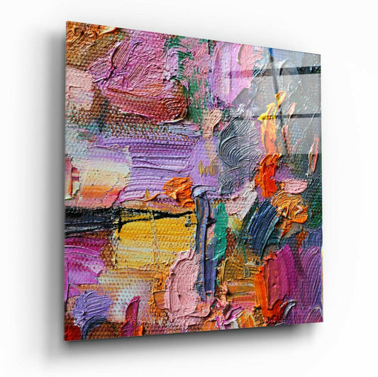 Angled perspective view of thick textured glass art panel featuring bold strokes of pink, purple, yellow, orange, and green paint applied with palette knife technique.