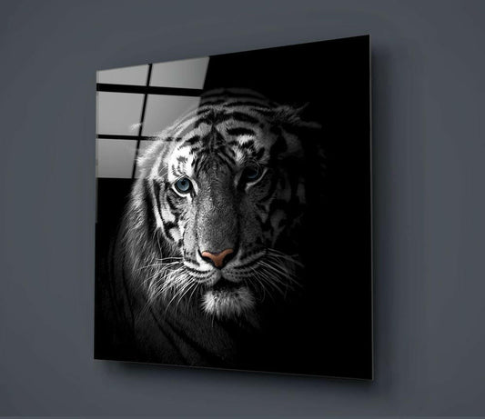 Black and white tiger portrait with striking blue eyes on glass wall art mounted on gray wall, showing grid pattern overlay.