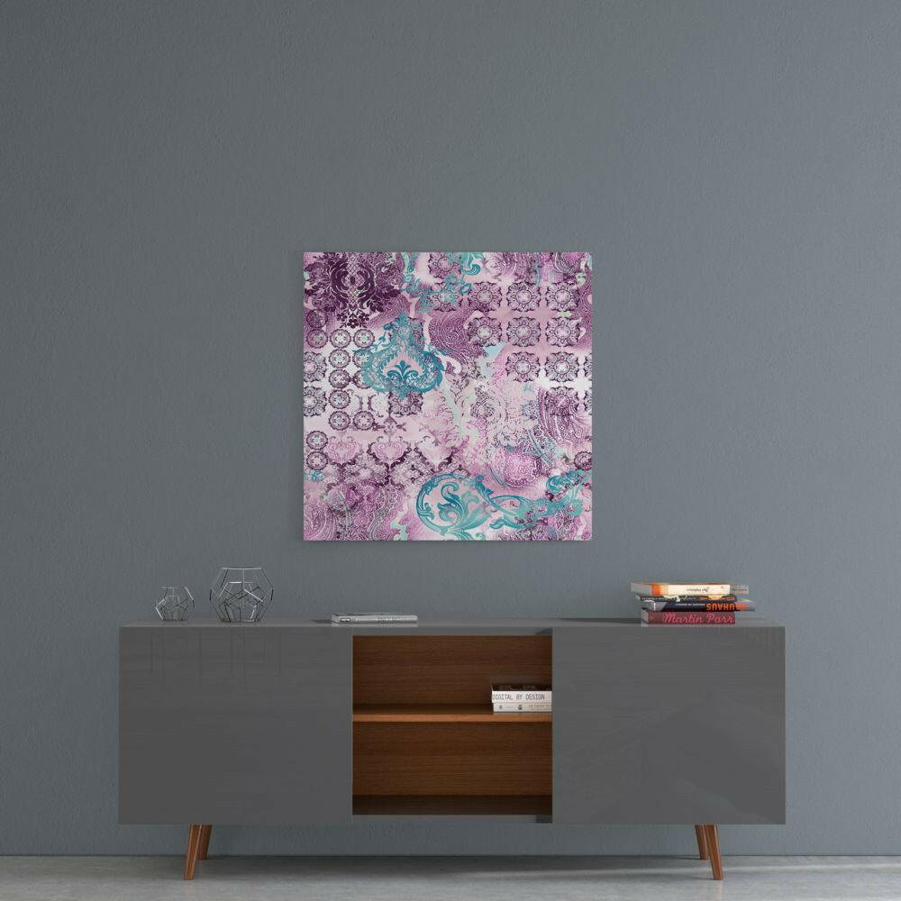 Purple damask glass wall art hanging above a mid-century modern console table with geometric decor items.