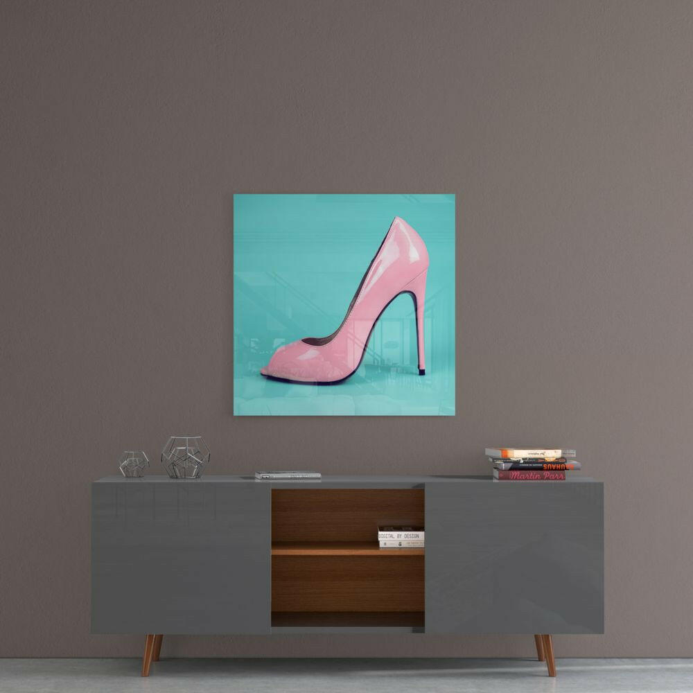 Pink glossy high-heeled shoe displayed on turquoise background, mounted above gray mid-century console table.