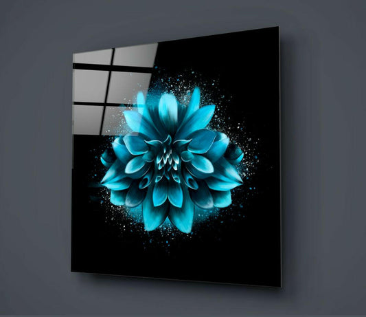 Angled view of black glass wall art displaying a luminous turquoise dahlia with particle effects against dark background.