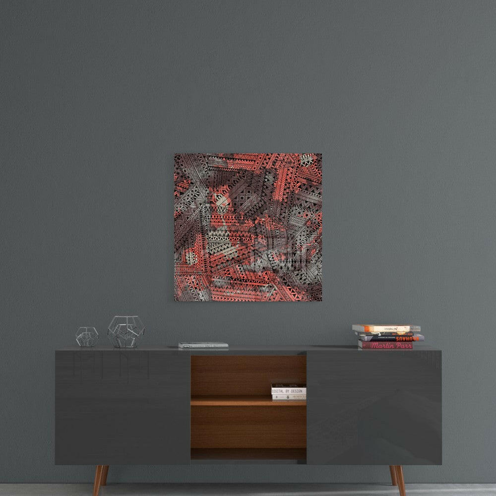 Square glass wall art with intricate red and gray geometric patterns displayed above mid-century modern console table.