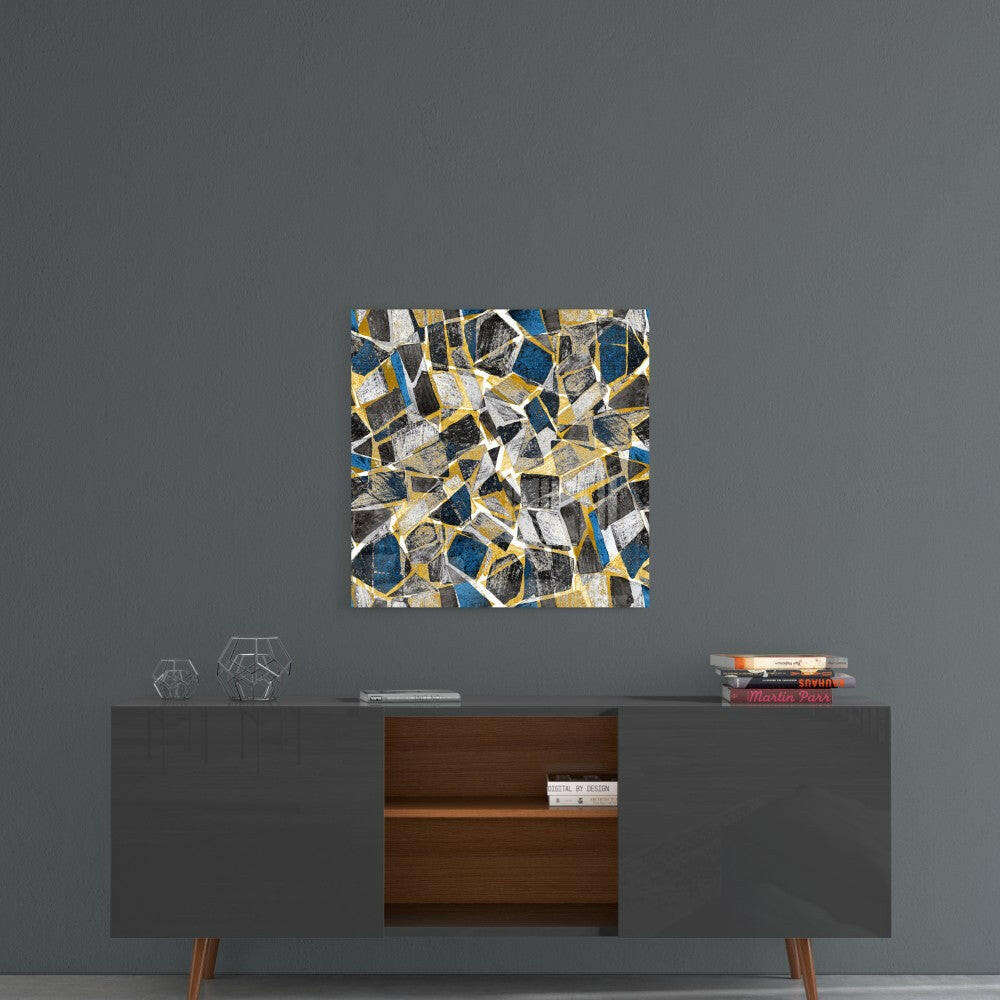 Abstract glass wall art with blue, gold, and gray geometric honeycomb pattern displayed above mid-century modern sideboard.