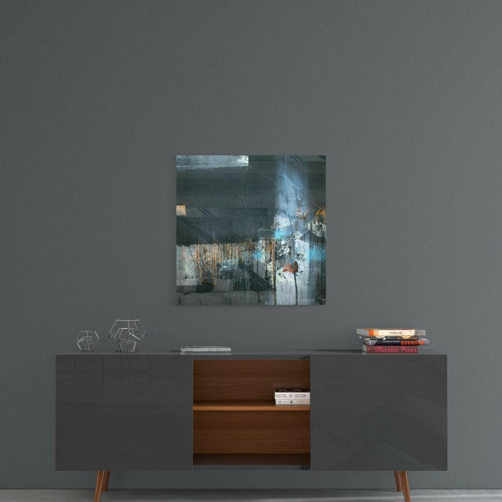 Lost Silhouette glass wall art hung above a mid-century modern credenza, displaying layered blue, white, and rust tones.