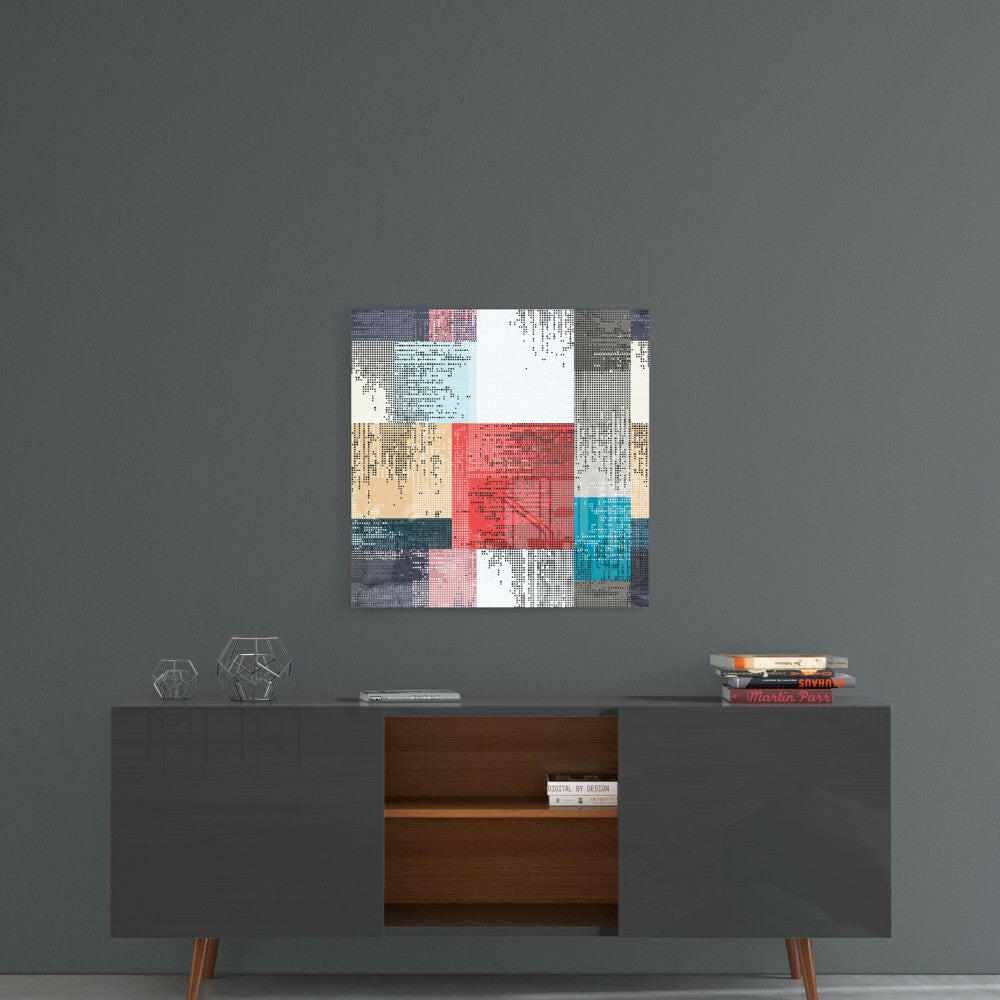 Patchwork glass wall art with red, blue, turquoise, tan, and grey pixelated squares displayed above a mid-century modern console table.