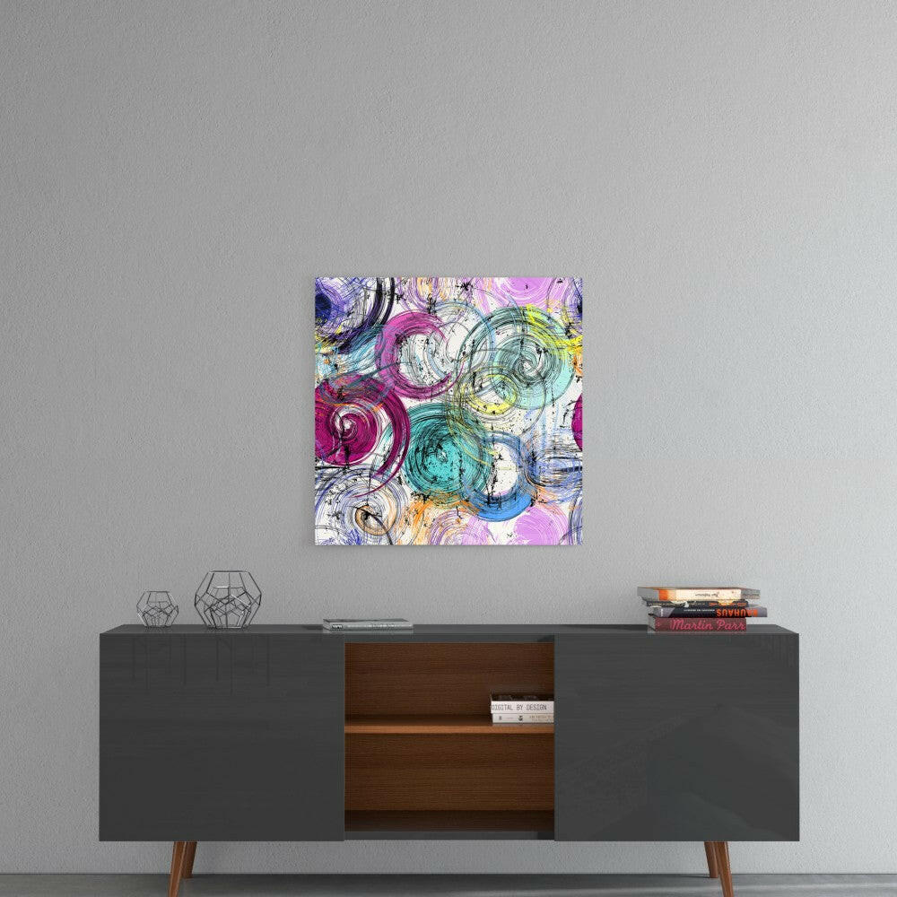 Colorful abstract snail shell glass art hanging above a mid-century modern console table in a minimalist interior setting.