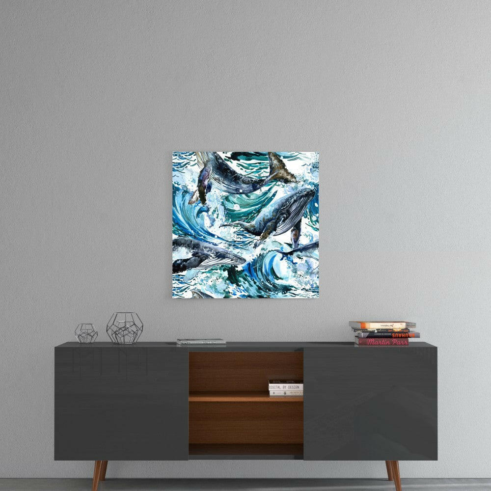 Glass wall art featuring stylized whales and swirling blue water patterns mounted above a mid-century modern console table.