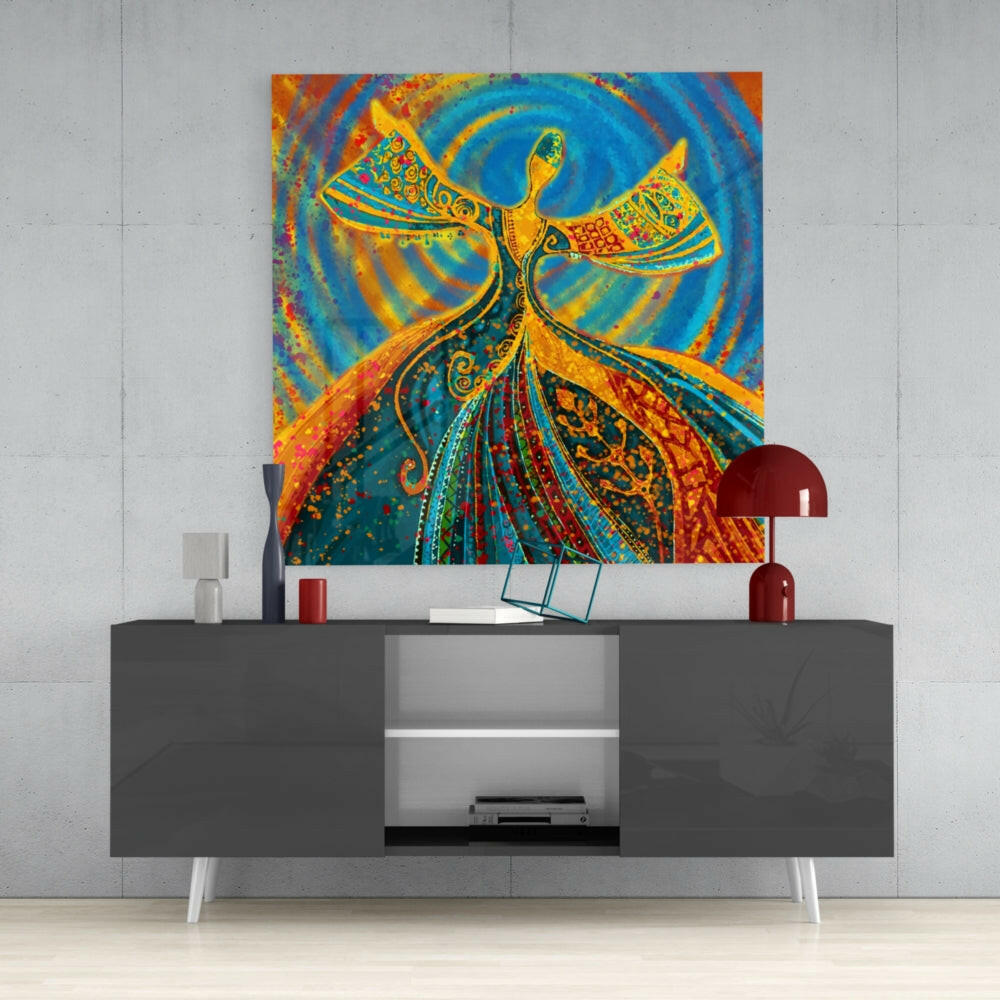 Colorful glass wall art depicting a gold and blue stylized angel figure displayed above a dark gray media console in a modern interior setting.