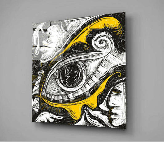 Square glass wall art displaying an ornate eye illustration in black ink with yellow accents, mounted on gray wall with shadow visible.