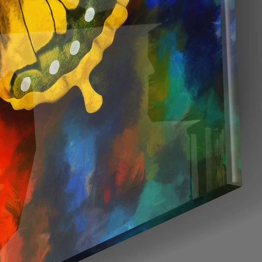 Yellow swallowtail butterfly glass wall art displayed at an angle, showing colorful painted background with red, blue, green, and yellow tones.