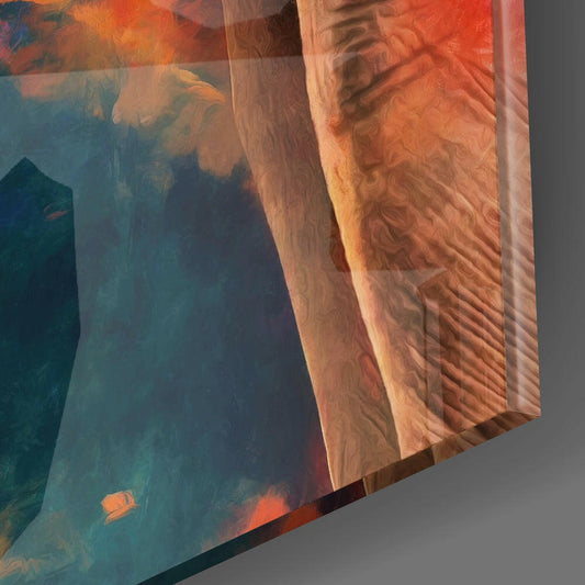 Close-up angled view of layered glass art showing translucent orange and teal panels with textured elephant profile detail.