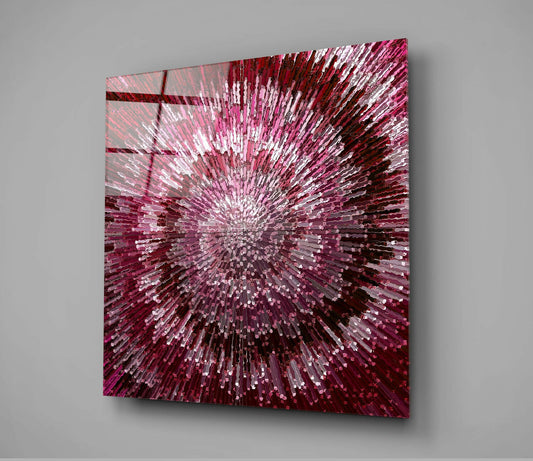 Square glass wall art with radial burst pattern in crimson, pink, and white against gray wall, angled perspective view.
