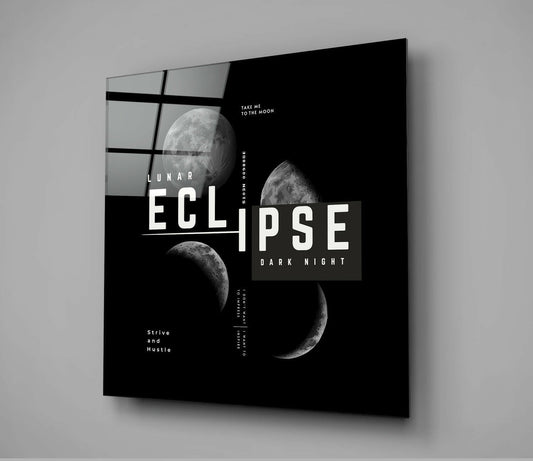 Angled perspective of black glass wall art featuring lunar eclipse phases, geometric grid pattern, and white typography on dark background.