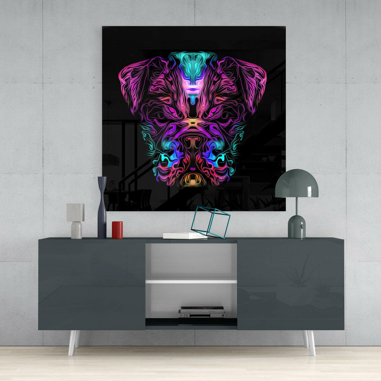 Neon angry dog glass wall art with magenta, cyan, and purple colors displayed above gray media console in modern interior setting.