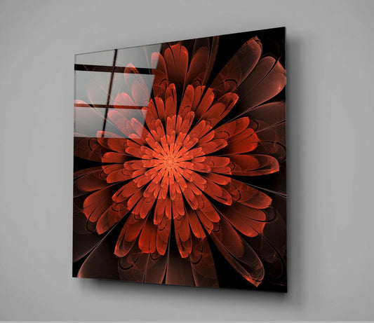 Angled view of red and orange fractal flower design on glass panel with black grid lines against gray wall.