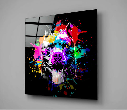 Angled view of black glass wall art featuring a colorful neon pitbull head with paint splashes against dark background.