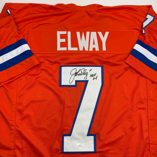 Orange Denver Broncos jersey number 7 with "ELWAY" printed on back and autographed signature visible on white number patch.