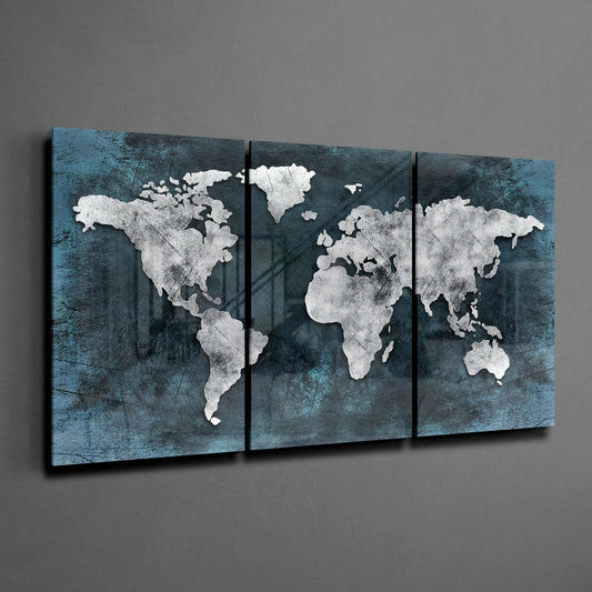 Three-panel teal and white world map glass wall art displayed on gray wall, showing continents in white against textured teal background.