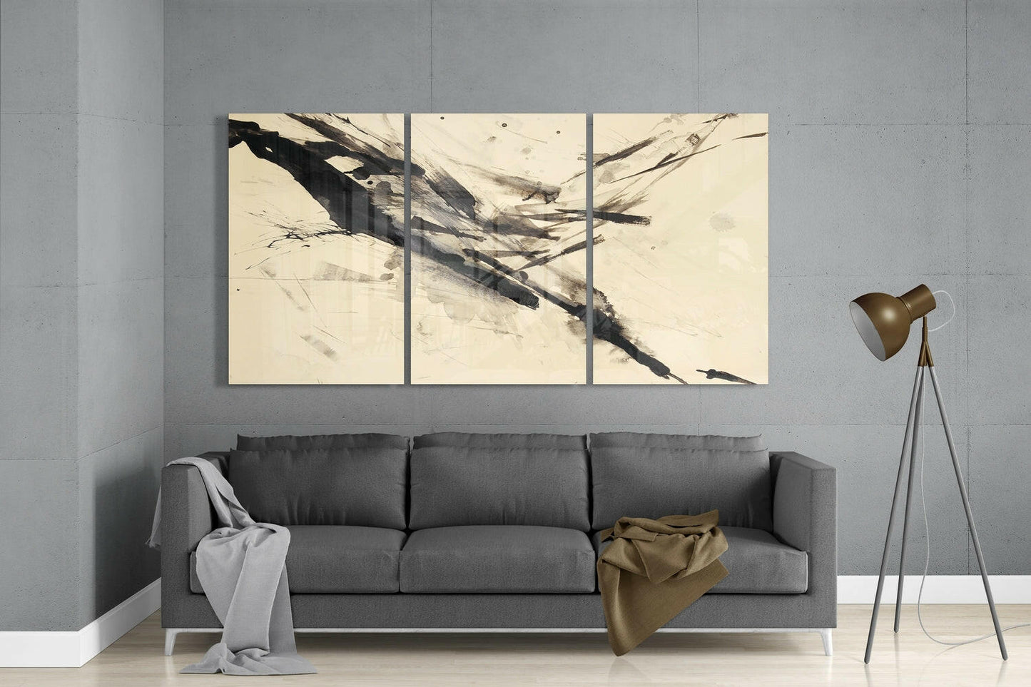 Three-panel cream and black abstract glass wall art hung above gray sofa in modern living room interior.