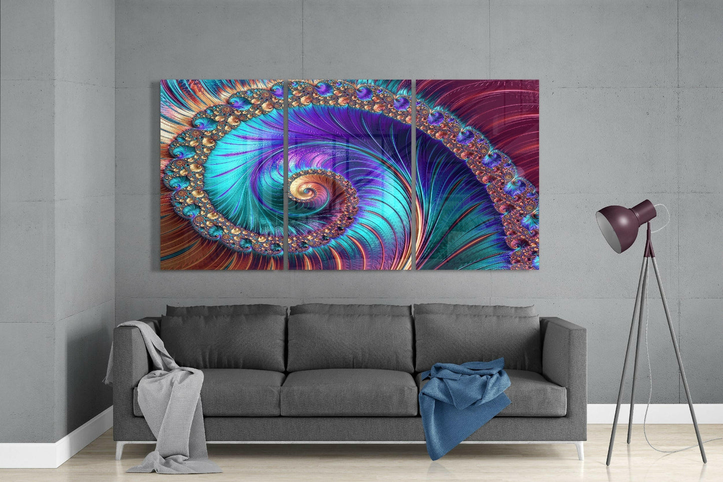 Colorful spiral peacock glass art triptych hung above gray sofa in modern living room interior.