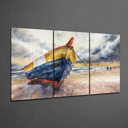 Three-panel watercolor glass art displaying a beached fishing boat with red, yellow, and blue hull on sandy shore with distant figures and cloudy sky.