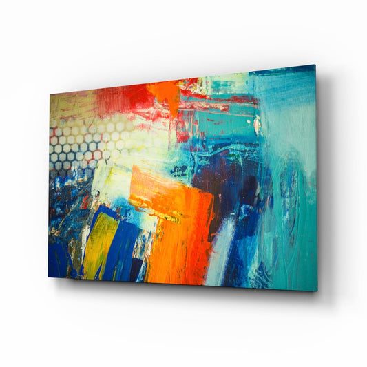 Abstract glass wall art panel displaying vibrant orange, blue, turquoise, and yellow brushstrokes with textured layering, shown at an angled perspective.