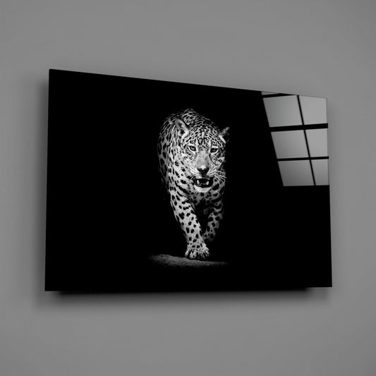 Black and white glass wall art displaying a stalking leopard against dark background, shown at an angle with illuminated glass panels visible on right edge.