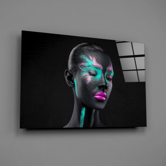 Glass wall art mounted on gray wall showing woman's profile with neon teal and pink brushstroke paint details and bright magenta lips.