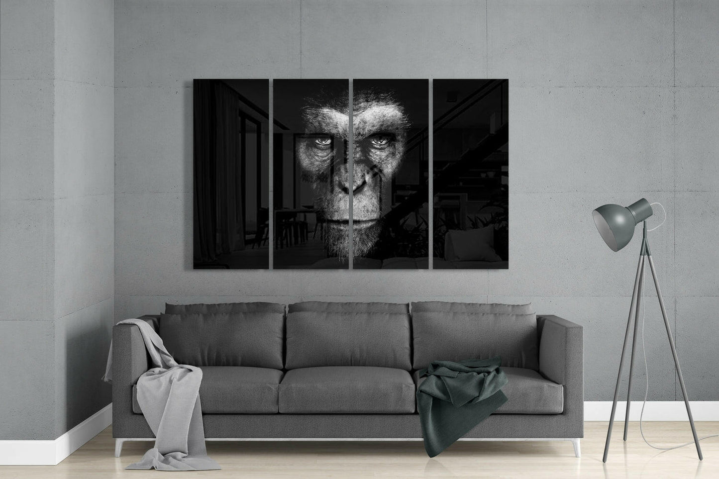 Four-panel black and white glass wall art displaying an intense primate face mounted above gray sofa in minimalist interior.