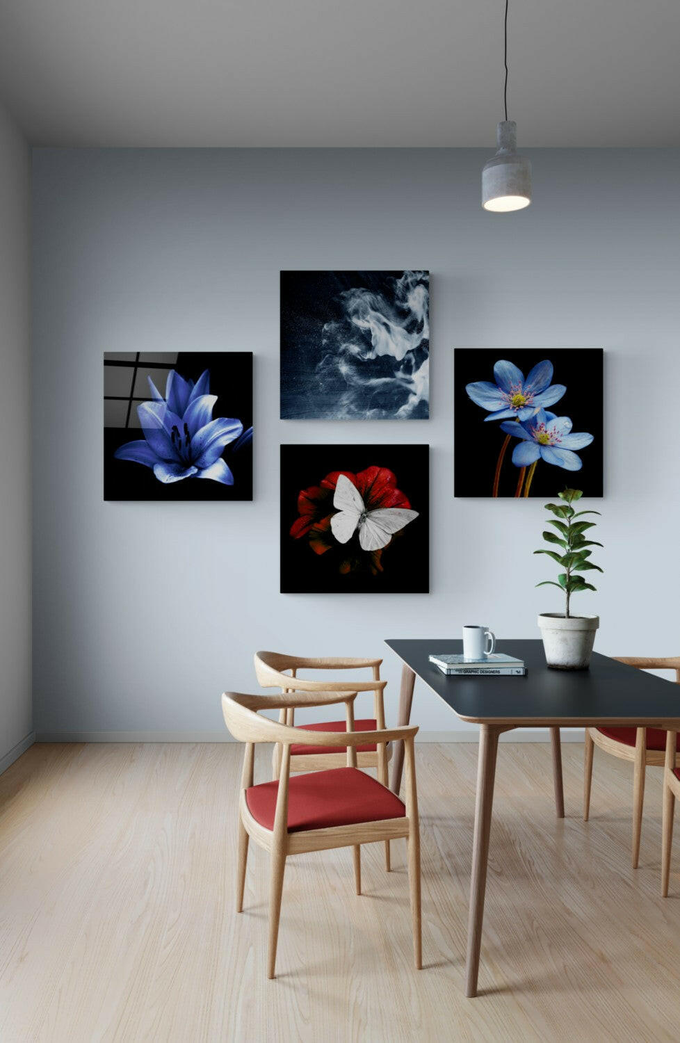 Modern dining room interior featuring four glass wall art panels displaying blue flowers, red and white butterfly, and dark cloudy imagery above wooden table and chairs.