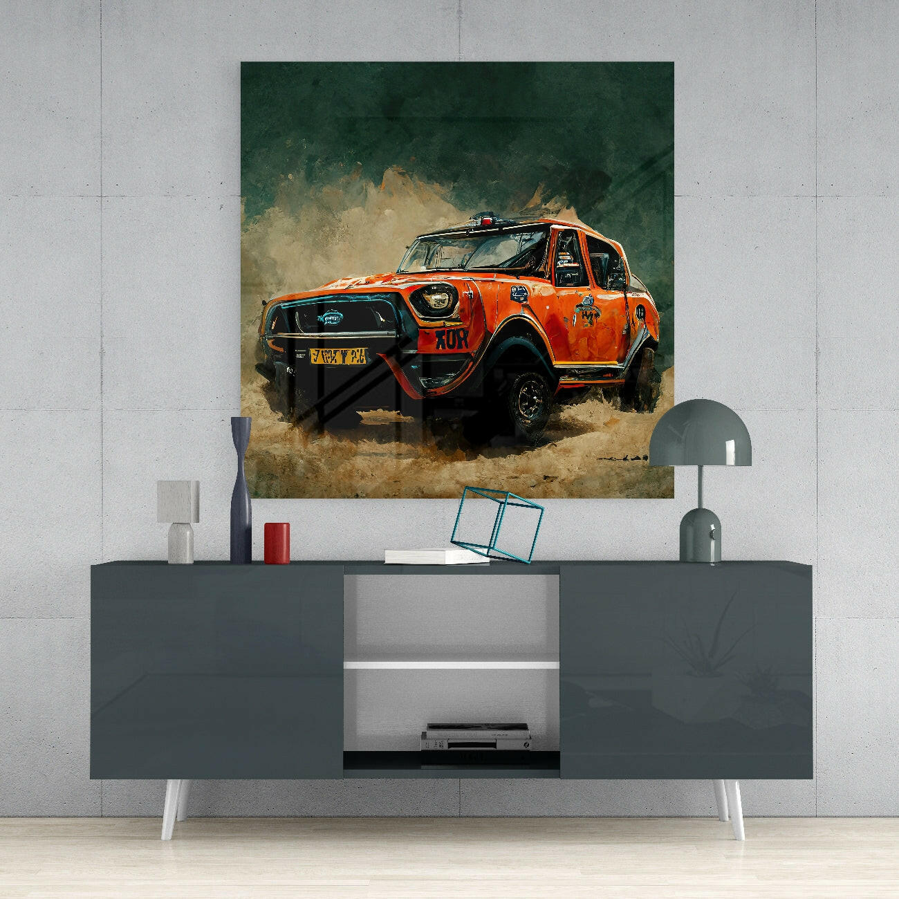 Orange rally vehicle kicking up dust on glass wall art displayed above gray media console in modern interior setting.