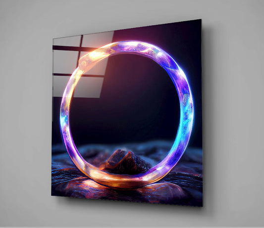 Glowing neon ring with blue, purple, and orange light standing upright on rocky terrain, displayed as wall-mounted glass art.