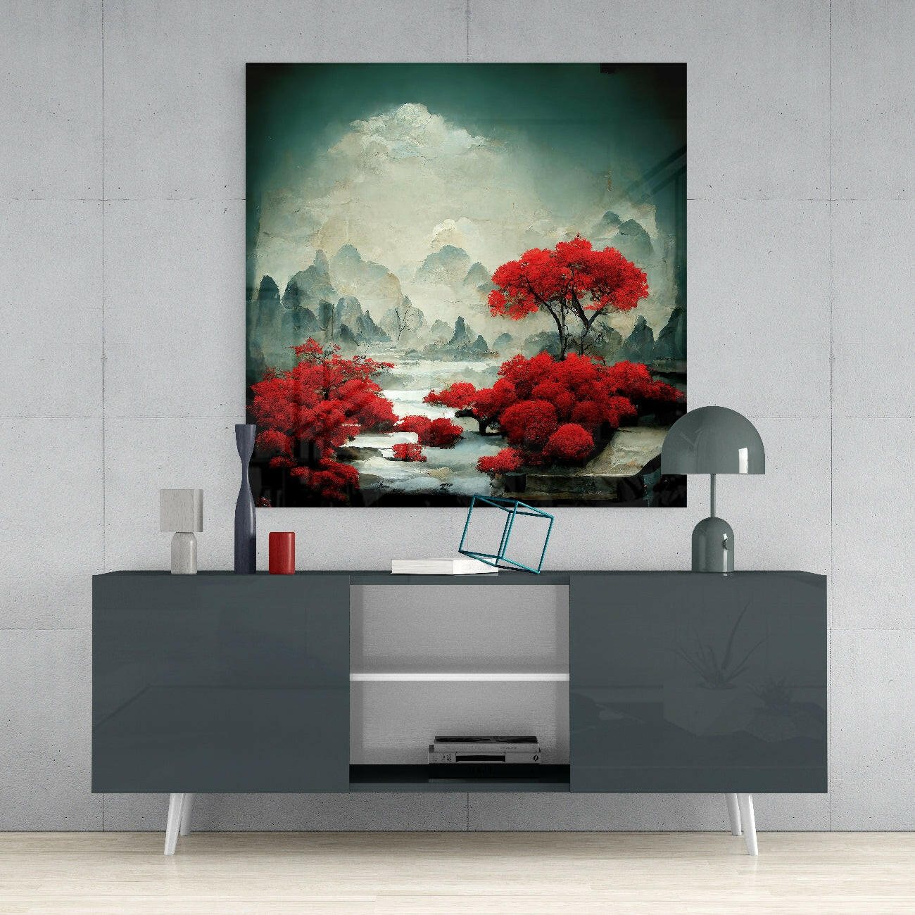 Red Forest Glass Wall Art displayed above a dark gray media console with white legs, showing vibrant red trees against misty mountains and water.