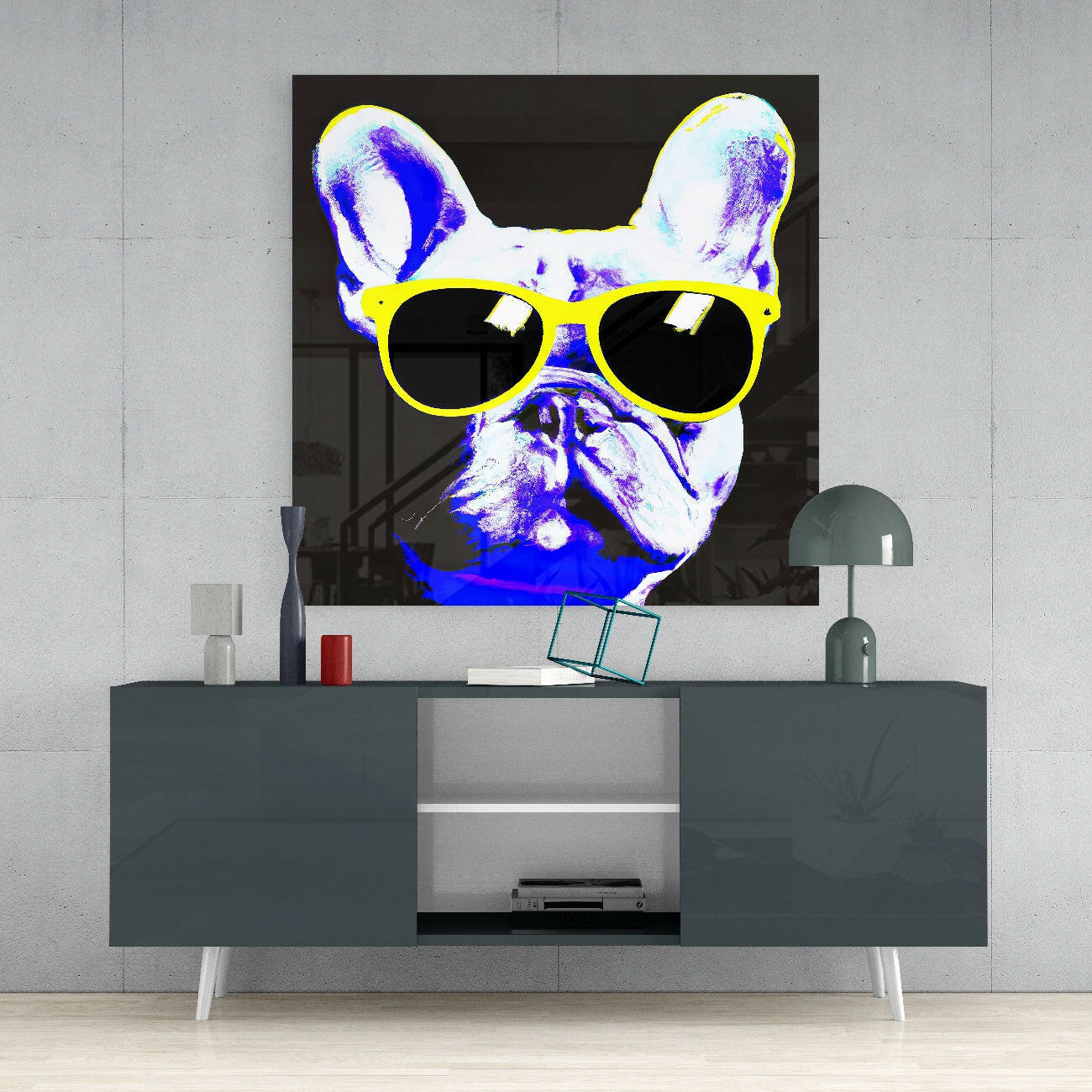 Neon pop art French Bulldog with yellow sunglasses mounted above dark gray credenza in contemporary interior setting.