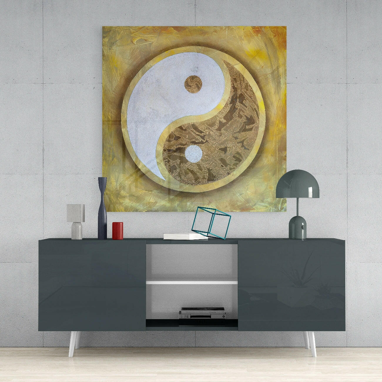 Gold-framed yin-yang glass wall art with white and textured brown sections displayed above a dark console table in a modern interior setting.
