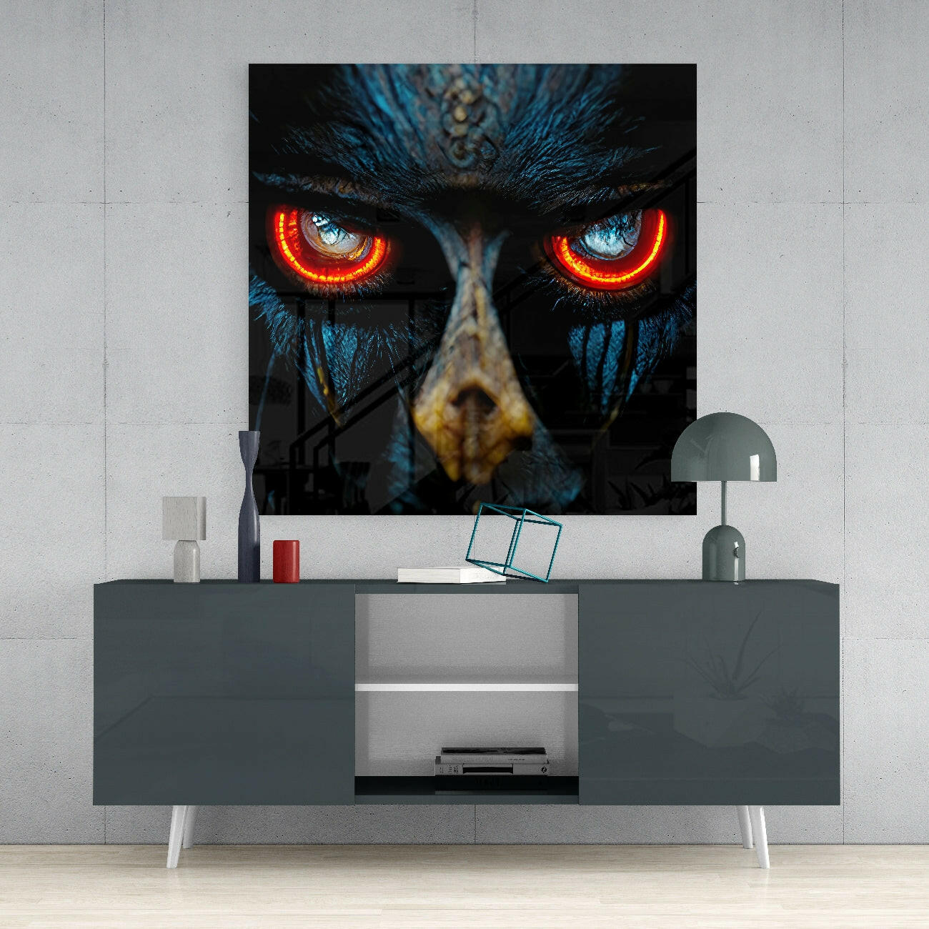 Black glass wall art featuring an owl's face with glowing red-orange eyes and blue feathers, displayed above a grey media console in a modern interior.