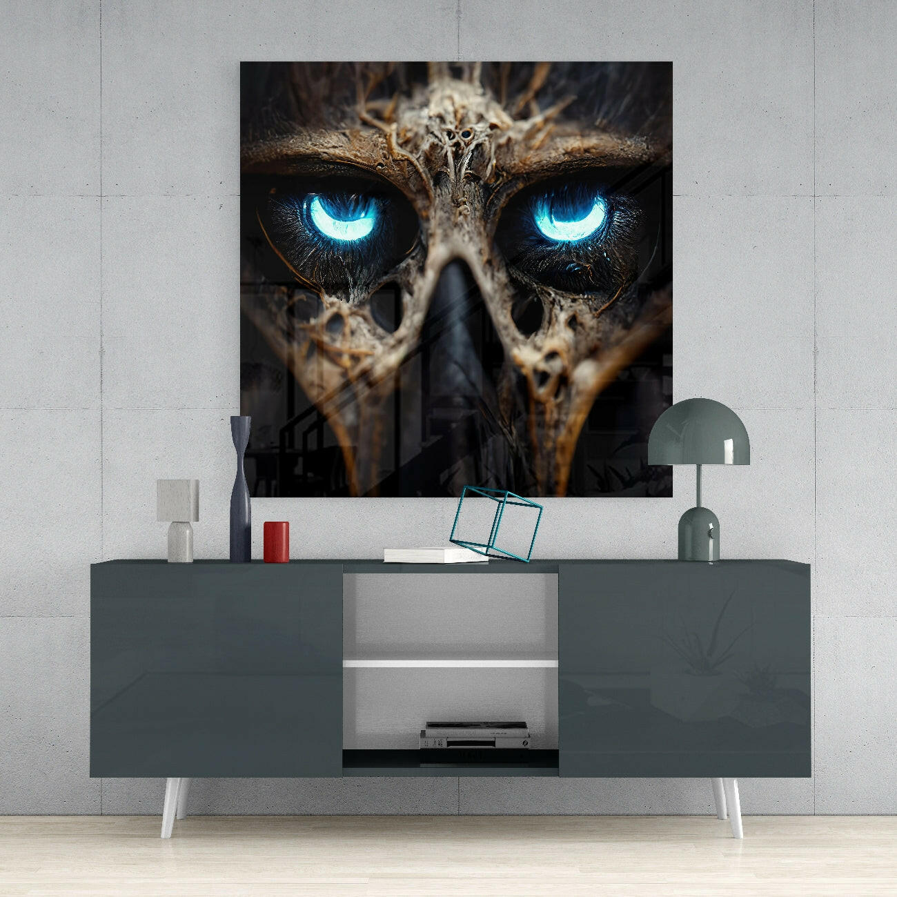 Glass wall art featuring a owl's face with glowing blue eyes displayed above a gray media console in a modern interior setting.