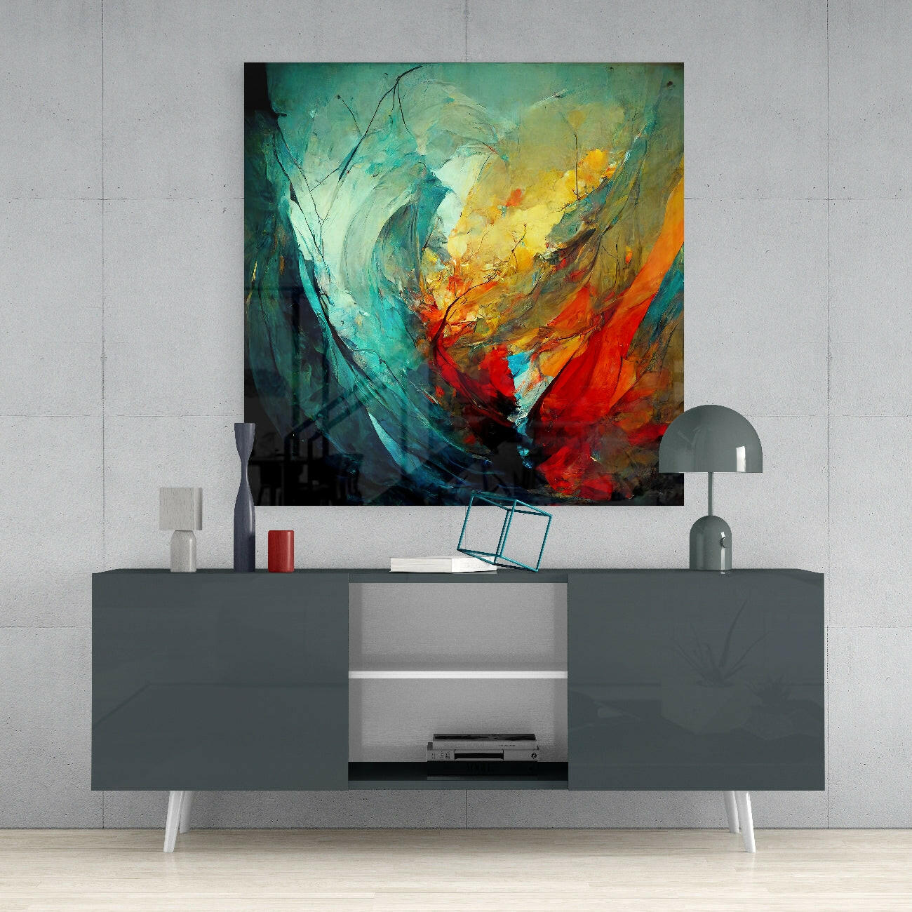 Abstract glass wall art in turquoise, yellow, orange, and red swirling colors mounted above a gray media console in a minimalist interior.