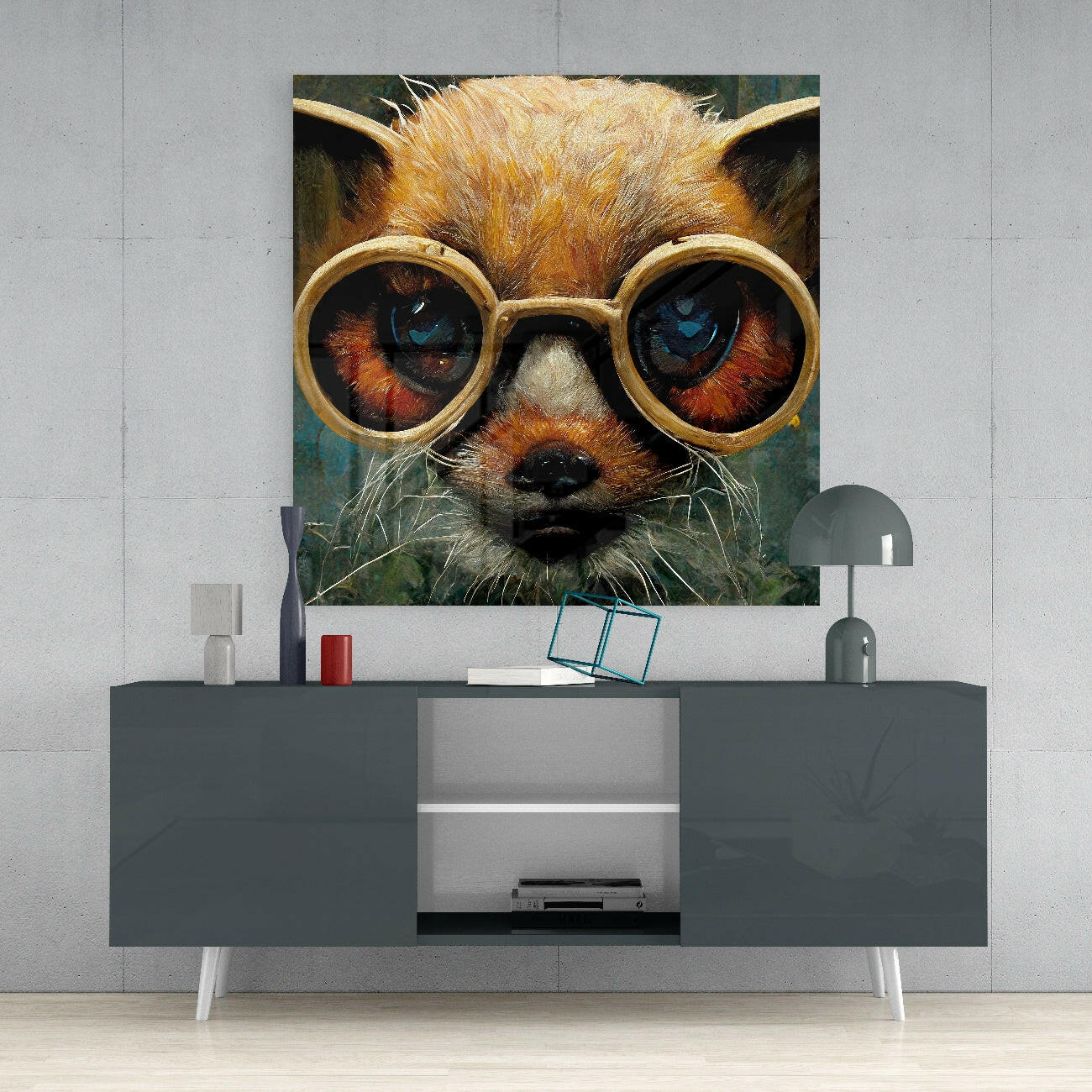 Whimsical glass art print of an orange cat wearing oversized round gold-framed glasses displayed above a modern gray console table.