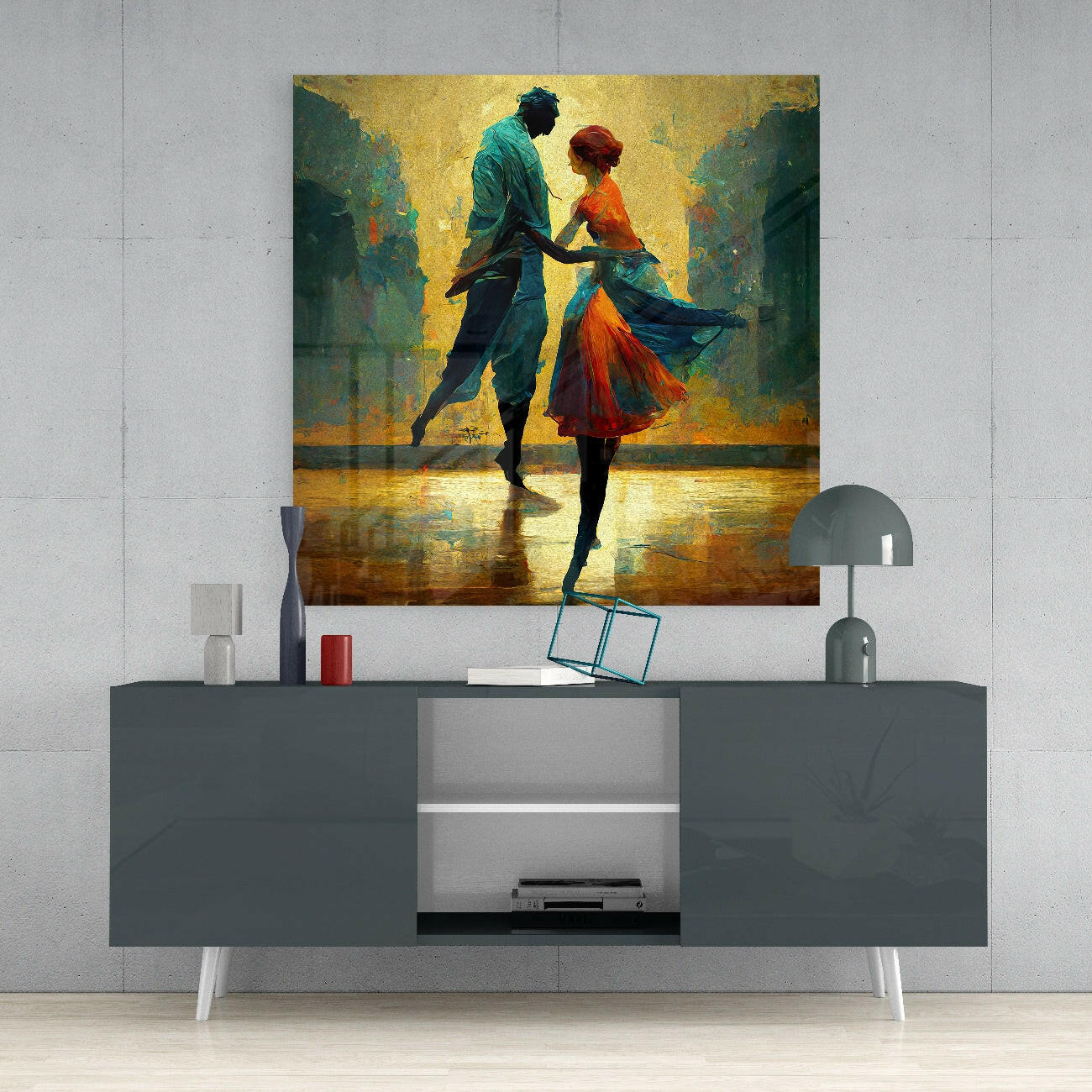 Glass wall art depicting two dancers in vibrant colors displayed above a gray mid-century modern console table in a minimalist interior setting.