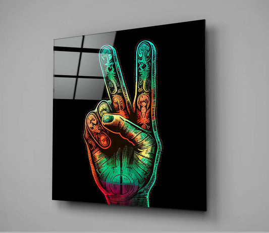Neon-colored glass wall art displaying a peace sign hand gesture with rainbow gradient tones against black background, mounted at angle.