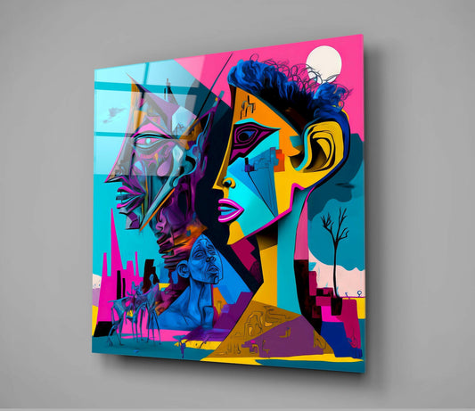 Angled view of colorful glass wall art featuring cubist faces in magenta, cyan, yellow, and blue with architectural cityscape elements and a moon, mounted on gray wall.