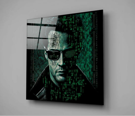 Angled view of black glass wall art displaying a man in sunglasses with green digital code overlay and grid pattern background.
