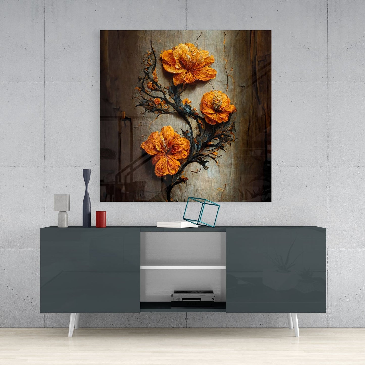 Orange flowers on dark branches displayed as glass wall art above a gray media console in a modern interior setting.